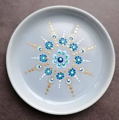 a white plate with blue and yellow designs on it