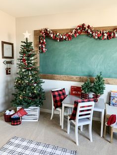 a christmas tree is in front of a chalkboard