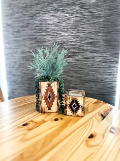 a wooden table topped with a potted plant next to a box on top of it