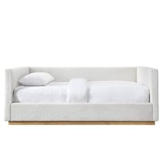 a bed with white sheets and pillows on it