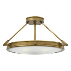 a semi flush ceiling light with an oval glass shade on the bottom and two lights above it