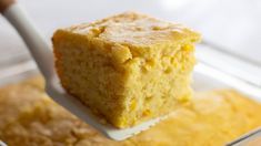 a piece of cornbread is being held by a fork