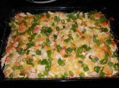 a casserole dish with green onions and cheese