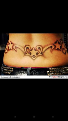 a woman's stomach with stars and hearts tattooed on the side by tattoo artist