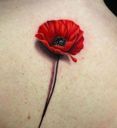 a red flower on the back of a woman's upper back shoulder and neck