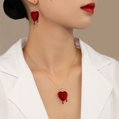 Blood drop red resin heart dripping with 2 droplets of ruby blood Material: Custom handcut resin heart Gold chain with an arrow toggle clasp in front Blood Drop Necklace, Heart Dripping, Sunglasses Necklace, Blood Drop, Sets Outfit, Red Blood, Ring Bag, Necklace And Earrings Set, Necklace And Earrings