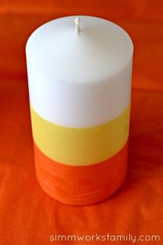 an orange, yellow and white striped candle