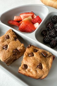 chocolate chip cookies, strawberries and berries on a white plate with two separate trays