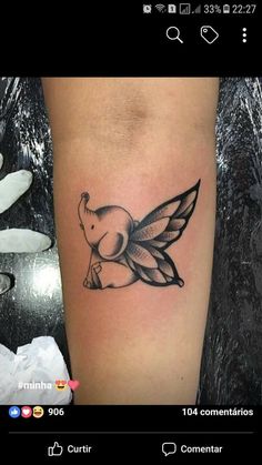 a small tattoo on the leg of a woman with a bird in it's wings