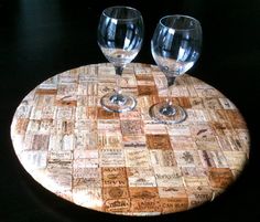 two wine glasses sitting on top of a cork board with words all over it,