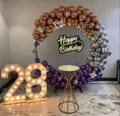 a birthday decoration with balloons and lights