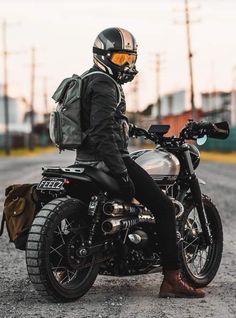 a man sitting on his motorcycle wearing a helmet