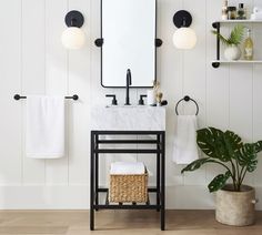 a bathroom with white walls and black fixtures