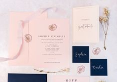 the wedding stationery is laid out on top of each other, including cards and envelopes