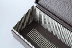 the inside of an empty box on a white surface with black and grey trims