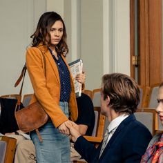 a woman is shaking hands with two other people