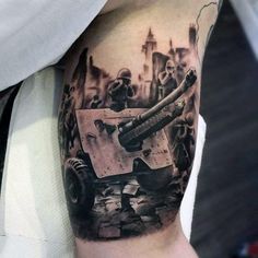 a man's arm with a tattoo on it that has a tank and soldiers in the background