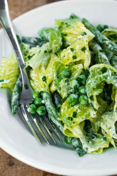 a close up of a plate of food with peas