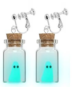 two glass bottles with corks on the top and one has a face drawn on it