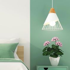 a bedroom with green walls and a white lamp hanging from the ceiling next to a bed