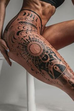 a woman's leg with tattoos on it