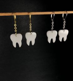 "Teeth buttons were so popular, there has become a new demand for teeth earrings! The perfect gift for a loved one who is in the dental industry or just has a fascination for teeth! Graphically designed and cut on out on opaque white acrylic using a laser. Assembled with your choice of gold or silver colored iron chain and brass leverback earring hooks. 1 3/4\" in length from top of hook to end of drop. For international buyers from Europe, Australia and North America: Please keep in mind that y Teeth Earrings, Teeth Earrings Clay, Tooth Earrings, Weirdcore Earrings, Goth Tooth Jewelry, Shark Teeth Earrings, 22k Gold Earrings, Teeth Shape, Weird Jewelry