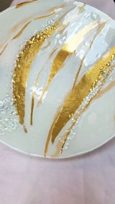 a white and gold plate sitting on top of a table