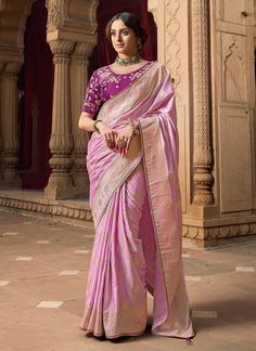 Experience the ultimate luxury with our Exclusive Pink Designer Saree! Made from Banarasi Silk with beautiful lace border, this saree is sure to make a statement. The contrast heavy embroidered blouse adds a touch of elegance and is perfect for any special occasion. Ideal for bridesmaids gifts. The unstitched blouse can be customized upto 44 inches. Do Note: All the accessories shown are for styling purpose only. Slight color variation may occur due to photographic reasons. Fall and Pico : Done Luxury Banarasi Silk Blouse Piece With Self Design, Luxury Banarasi Silk Blouse Piece For Women, Luxury Pink Banarasi Silk Blouse, Luxury Silk Blouse With Embroidered Border, Elegant Luxury Blouse Piece With Embroidered Border, Luxury Embroidered Banarasi Silk Saree, Elegant Luxury Banarasi Silk Blouse Piece, Luxury Banarasi Silk Women's Blouse Piece, Elegant Luxury Banarasi Silk Blouse