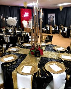 a black and gold table setting with place settings