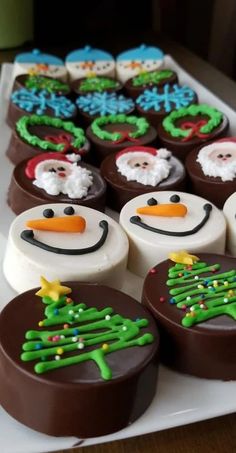 there are many decorated desserts on the table together, including snowmen and christmas trees