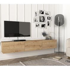 a flat screen tv sitting on top of a wooden entertainment center in a living room