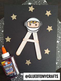 an astronaut craft made out of popsicle sticks and glue