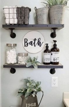 a bathroom with two shelves above the toilet and a potted plant next to it