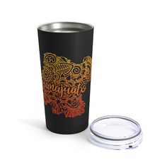 a black tumbler with an orange and yellow pattern on the side next to a white lid