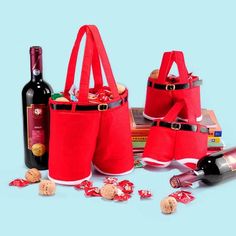 three red bags with wine bottles and corks next to each other on a blue background