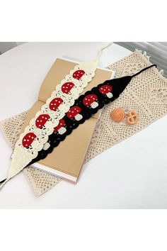 an open book on top of a doily with red and white polka dot decorations