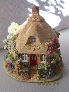 a small house made out of clay sitting on top of a table