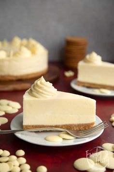 a piece of cheesecake on a plate with a fork and some almonds around it