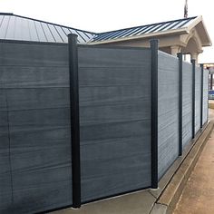 a wooden fence next to a building