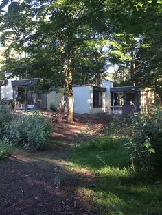 a house in the woods with lots of trees around it