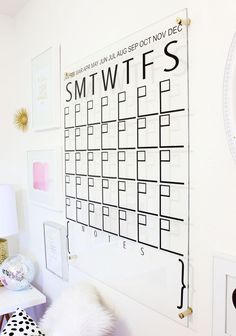 a white wall with a black and white calendar on it