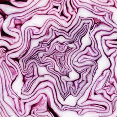 an image of red cabbage in the middle of it's cut up spiral pattern