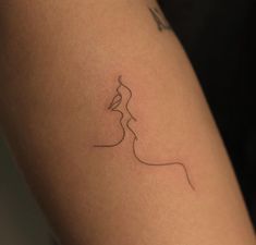 a woman's arm with a small tattoo on the left side of her leg