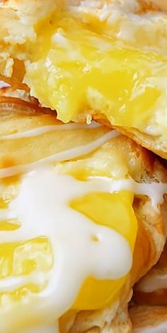 an egg and cheese sandwich is shown on a white plate with some sour cream drizzled over it