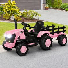 a pink toy tractor parked in front of a house