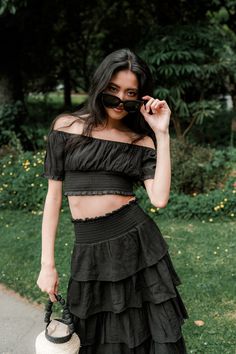 Introducing the Sofia Black Skirt Set – the trendiest two-piece for any season! The black maxi skirt features a ruffle detail and an elastic waist, paired with an off-the-shoulder crop top. Whether you're going out for lunch with the gals or jet-setting off on a vacay, this set is a year-round classic! Black Chic Cropped Off-shoulder Top, Chic Black Cropped Off-shoulder Top, Cropped Skirt For Summer Night Out, Summer Night Out Ruffled Maxi Skirt, Black Ruffled Maxi Skirt For Summer, Spring Ruffled Maxi Skirt For Night Out, Chic Black Off-shoulder Top For Summer, Off-shoulder Crop Top For Date Night In Summer, Black Ruffled Crop Top For Spring