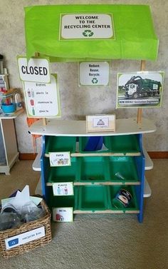 a green shelf with several items on it in front of a sign that says welcome to recycling center