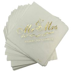 six wedding napkins with gold foil on the front and back, each folded in different sizes