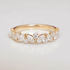 a yellow gold ring with five pear shaped diamonds