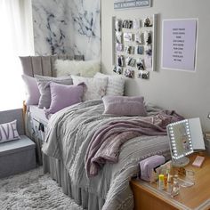 a bed room with a neatly made bed and pictures on the wall above it's headboard